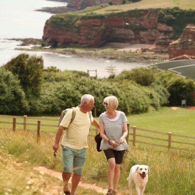 Couple walking with their dog at Ladram Bay Holiday Park