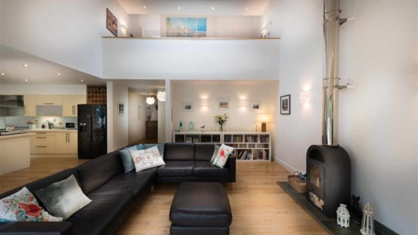 Open plan living room with wood burner