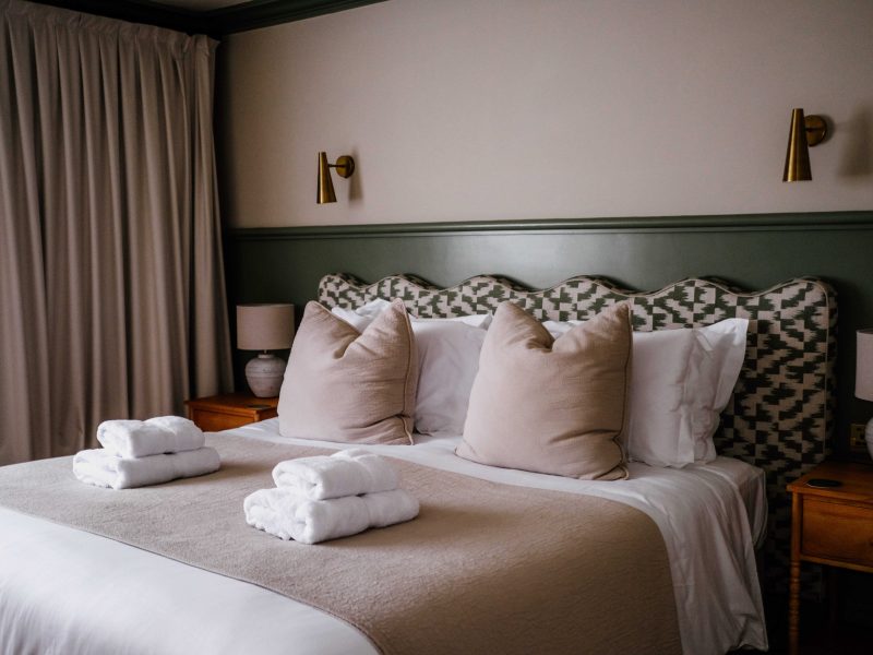 Bedroom with patterned cushions at Dartmoor Lodge, Devon