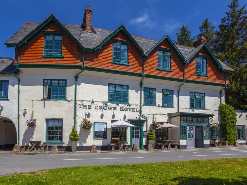 The white-fronted Crown Hotel in Exford, a 17th-century coaching inn with red-tiled gables, in the heart of Exmoor National Park