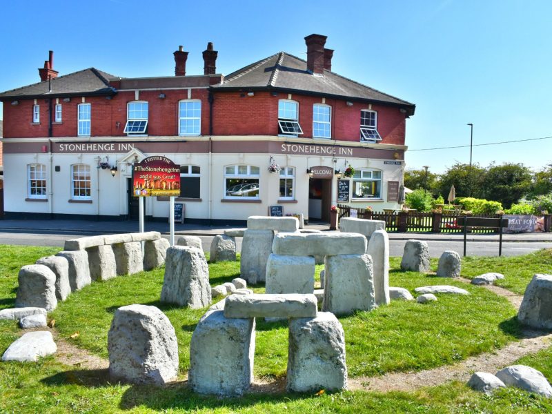 The replica Stonehenge stone circle on the lawn in front of the Stonehenge Inn, Durrington, on a sunny day