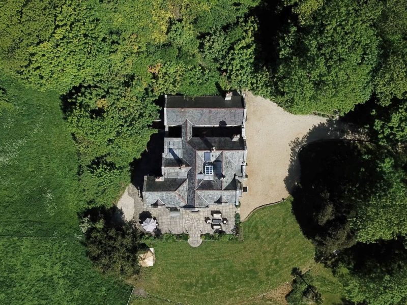 Aerial view of Upwey House surrounded by trees, lawns and woodland in its 23 acres of Dorset grounds