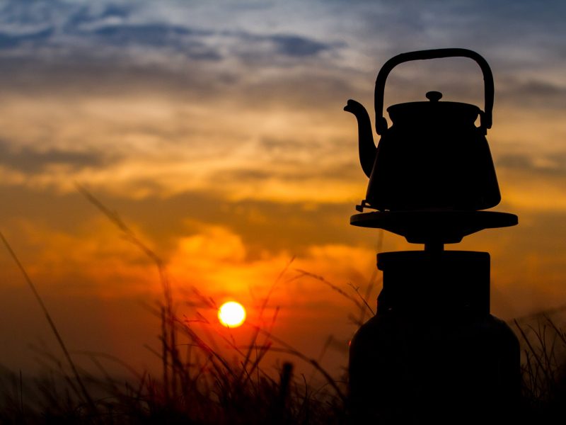 Camping kettle silhouetted against the sunset at Tucker's Grave Inn